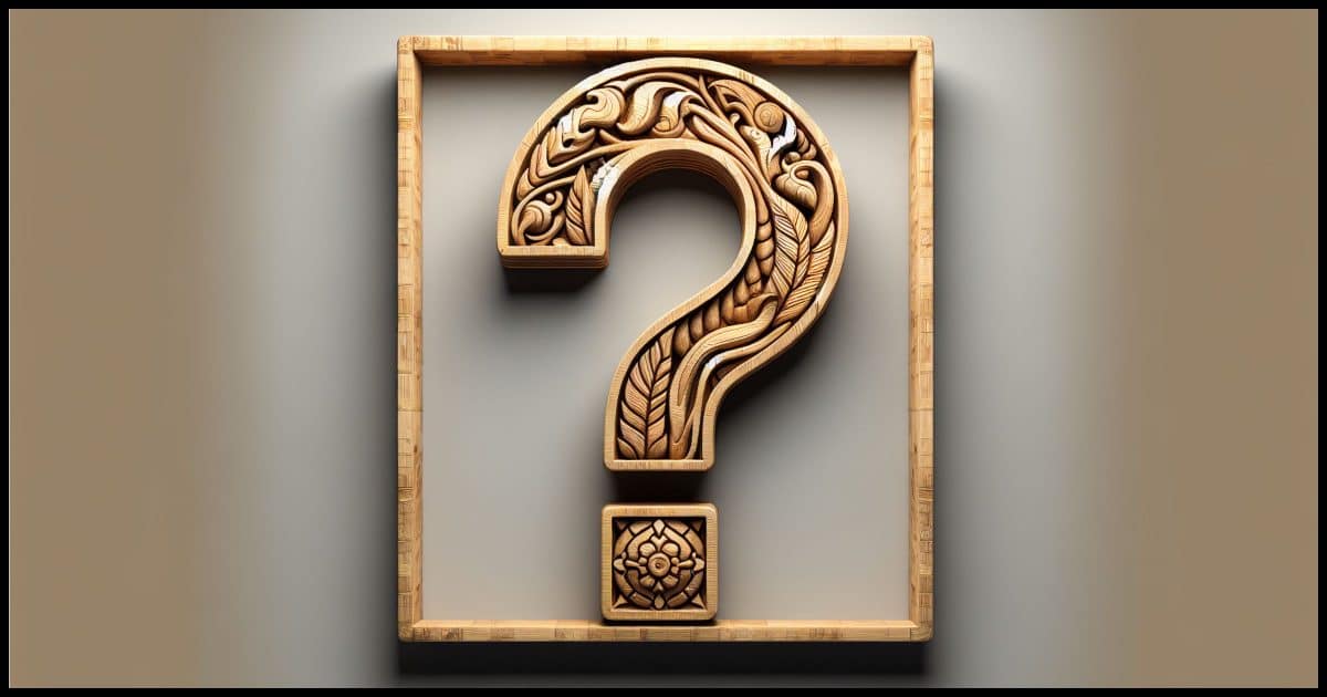 A wood relief carving of a question mark.