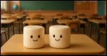 Two marshmallows siting on an otherwise empty table top in a gradeschool classroom.